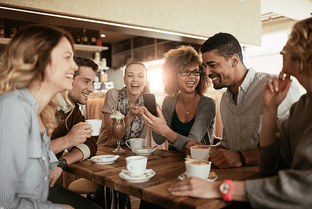 Group sitting at a table drinking coffee